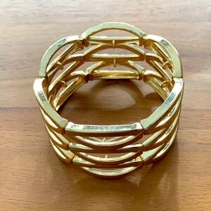 UEC Costume gold tone bracelet. 6 panels stretch on clear elastic cord. Light.